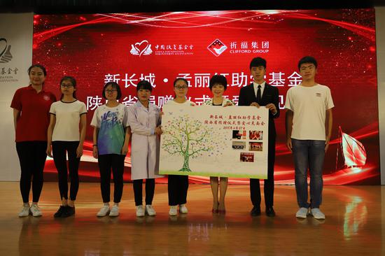 7所高校学生代表向孟丽红女士赠送全体学生签字指纹树